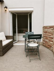 a patio with a table and a chair and a couch at Cozy Apartment with Terrace & Free Parking in Würzburg