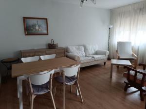 a living room with a table and a couch at Casa Montse-Izquierda in Colombres