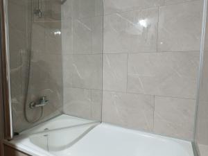 a shower with a glass door and a tub at Casa Montse-Izquierda in Colombres