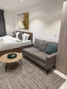 a living room with a couch and a bed at Spacious Studio Apt Airport Residential in Accra