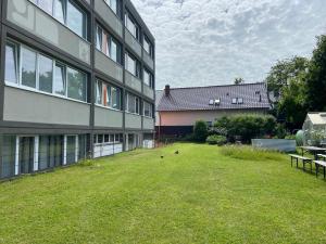 a grassy yard next to a building with a building at Hostel Stralsund in Stralsund