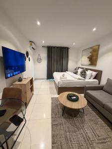 a living room with a couch and a table at Spacious Studio Apt Airport Residential in Accra