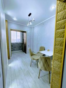 a dining room with a table and chairs at Taraz 2 in Taraz