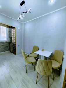 a dining room with a table and chairs at Taraz 2 in Taraz +13 photos