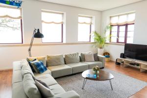 a living room with a couch and a tv at Spacious Villa with Private Pool & Garden in Douro, by Hopstays in Sabrosa