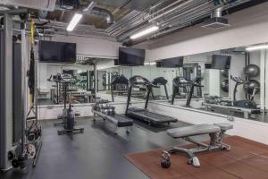 a gym with several treadmills and exercise machines at Buckle Street Studios by Locke, Aldgate in London