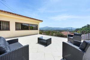 a patio with two chairs and a table at Casa da Galheira with Swimming Pool by Sé Apartamentos in Vilela