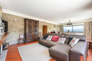 a living room with a couch and a table at Casa da Galheira with Swimming Pool by Sé Apartamentos in Vilela