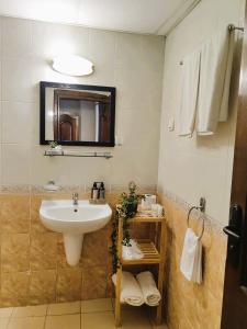 a bathroom with a sink and a mirror at Family Hotel Brilliance in Varna City +42 photos