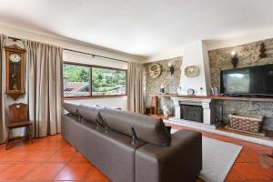 a living room with a couch and a fireplace at Casa da Galheira with Swimming Pool by Sé Apartamentos in Vilela