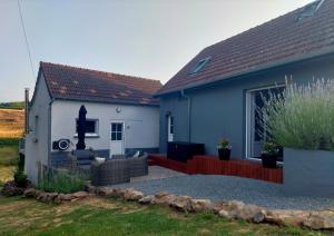 a blue and white house with a couch in a yard at Maison du Grand Moulin in Saint-Aubin-en-Charollais