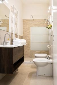 a bathroom with a toilet and a sink at San Felice Central Room in Bologna +75 photos
