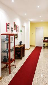 a room with a red carpet and a desk and a red rug at San Felice Central Room in Bologna