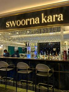 a bar in a restaurant with a sign that reads swonia karma at Swoorna Kara in Kathmandu