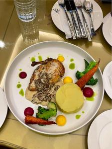 a plate of food with chicken and vegetables on a table at Swoorna Kara in Kathmandu