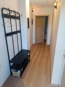 a black bench sitting in the middle of a hallway at Solea Apartment in Woditz