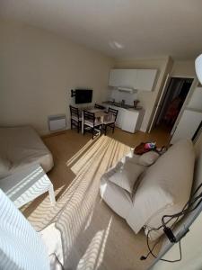 a living room with a couch and a table at Domaine jard mer in Jard-sur-Mer