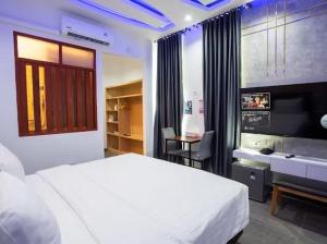 a bedroom with a large white bed and a desk at เซฟเฮ้าส์ รีสอร์ท in Pattani