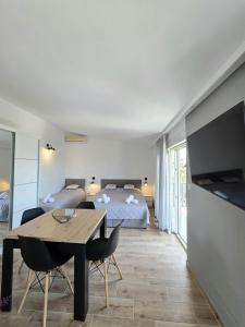a living room with a table and a bed and a bedroom at Apartments Sunce in Podaca