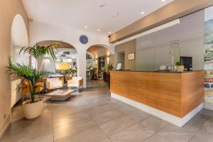 a lobby of a hospital with a reception counter at Hotel Quarcino in Como