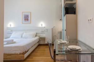 a bedroom with a bed and a glass table at Syntagma Gem 2 in Athens