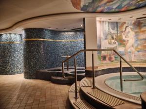 a bathroom with a jacuzzi tub in a building at Cityhotel Goldener Adler B&B in Chiusa