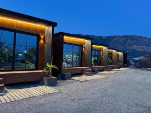 a row of buildings with plants in front of them at Paradise Beachfront Chalet Rooms Borsh in Borsh