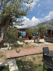a wooden walkway in front of a house at Paradise Beachfront Chalet Rooms Borsh in Borsh