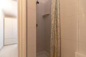 a shower with a shower curtain in a bathroom at Vista Corsica in Isola Rossa +23 photos
