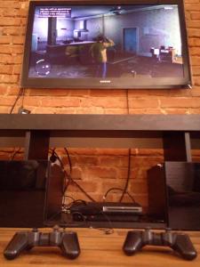 a tv sitting on a table with a video game controller at TG Krakowska Kamienica in Tarnowskie Góry