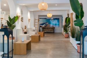 a room filled with lots of furniture and plants at Hotel Playas de Paguera in Paguera