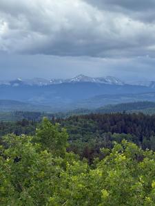 a view of snow covered mountains in the distance at The Wandering Antler - Bragg Creek in Bragg Creek