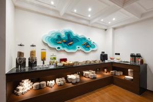 a display case in a room with food on display at ELYSIUM Premier Suites Hitec City in Hyderabad
