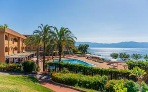 a view of a resort with a swimming pool and the ocean at Altafiumara Resort & Spa in Villa San Giovanni