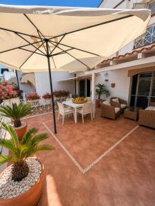 a patio with a table and an umbrella at B&B L'ORIZZONTE in Crotone