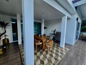 a dining room with a table and chairs at Keya Mountain View Pool Villa Samui in Ban Thung
