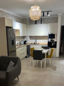 a kitchen with a table and chairs and a dining room at Chalet in north coast in El Dab‘a