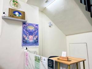 a room with a table and a sign on the wall at 回巢 歸宿 Hui Chao Gui Su 民宿編號2121號 in Taitung City