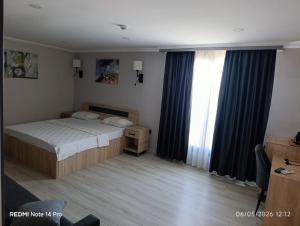 a bedroom with a bed and a large window at Green Side Leon Hotel in Side