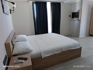 a bedroom with a large bed and a television at Green Side Leon Hotel in Side