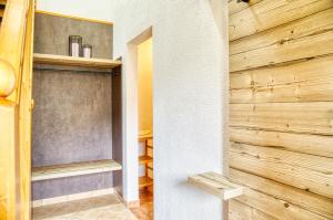 a walk in closet with a wooden wall at Appartements Spitaler in Ried im Zillertal +69 photos