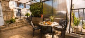 a patio with a table and chairs on a balcony at Apartment Nereo in Senj +8 photos