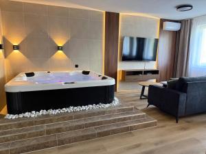 a living room with a hot tub and a couch at Heaven SPA Eger in Eger +15 photos