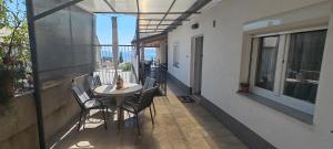 a balcony with a table and chairs on a building at Apartment Nereo in Senj