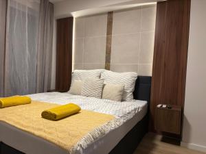 a bed with two yellow pillows on top of it at Heaven SPA Eger in Eger