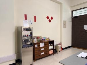 a room with a refrigerator and a dresser and a door at 回巢 歸宿 Hui Chao Gui Su 民宿編號2121號 in Taitung City +56 photos