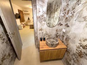 a bathroom with a sink and a mirror on a wall at VaSaMi - Appartamento in centro in Bari +98 photos