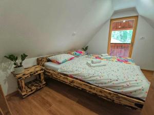 a bedroom with a large bed with polka dot sheets at Gorsko zavetje Cottage in Soča