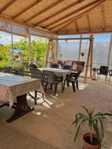 a patio with tables and chairs and a view of the ocean at Apartments Vlavcheski in Peštani