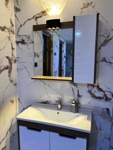 a bathroom with a sink and a mirror at Hotel Gazi in Gaziantep +11 photos